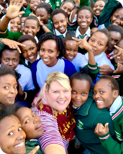 Carrasquilla and Silantio stading in the middle on the tech girls at A.C. Moi Girls School in Samburu, Kenya